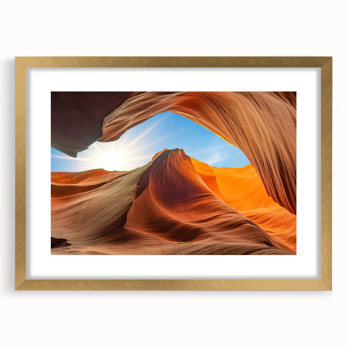 Framed wall art depicting a serene landscape with intricate rock formations, accented by a gold frame and matting, ideal for modern home decor. The artwork evokes tranquility and complements various interior styles.