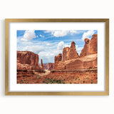 Framed wall art featuring a stunning landscape design with rocky formations, accented by a gold mat and frame, ideal for enhancing modern home decor.