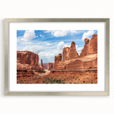 Framed wall art collection featuring a serene landscape with rocks, showcased in a silver frame and mat, perfect for home decor enhancement.