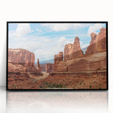 Framed acrylic wall art featuring a striking landscape design with rocky formations, presented in a sleek black frame, ideal for modern home decor.