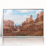 Framed acrylic wall art showcasing a stunning landscape design with rocky formations, highlighted by a white frame, perfect for home decor in modern interiors.