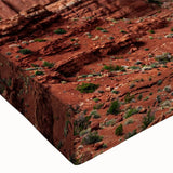 Close-up of a stretched canvas artwork featuring a vibrant landscape design with textured rocks and earthy tones, perfect for home decor and wall art enthusiasts.