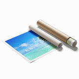 Vibrant rolled print of a serene seascape, showcasing calm ocean waves and a colorful sunset sky, perfect for enhancing home decor in coastal themes.