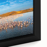Framed canvas wall art showcasing a vibrant seascape design with rich blues and greens, highlighting detailed ocean waves and a serene coastal atmosphere.