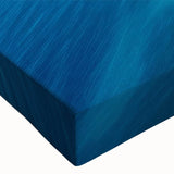 Close-up of a vibrant stretched canvas wall art piece showcasing a serene seascape design with rich blues and soft whites, perfect for coastal home decor.