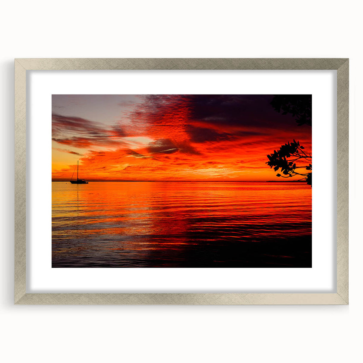 Framed wall art featuring a serene seascape design with soft blue and white hues, showcasing waves and clouds, elegantly matted and set in a sleek silver frame. Ideal for coastal-themed decor or a calming living space.