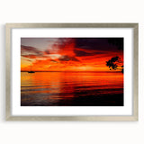 Framed wall art featuring a serene seascape design with soft blue and white hues, showcasing waves and clouds, elegantly matted and set in a sleek silver frame. Ideal for coastal-themed decor or a calming living space.