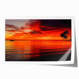 Vibrant seascape wall art print showcasing a serene sunset over calm waters, featuring rich blues and warm oranges, rolled and ready for framing.
