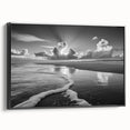 Framed canvas wall art showcasing a serene seascape design, featuring calming blue and white hues, ideal for home decor. The black frame adds elegance to any room.