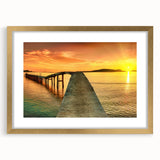 Gold-framed wall art showcasing a serene seascape design, featuring soft blue and white waves, perfect for enhancing coastal home decor.