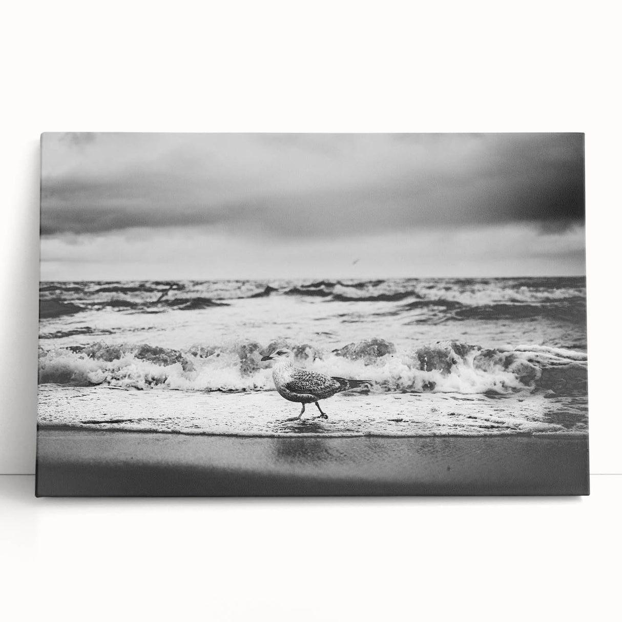 Stretched canvas wall art collection showcasing vibrant landscapes and seascapes, elegantly leaning against a neutral wall, perfect for enhancing home decor.