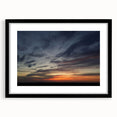 Black-framed wall art print showcasing a serene landscape and skyscape design, featuring soft blues and greens, perfect for enhancing modern home decor.