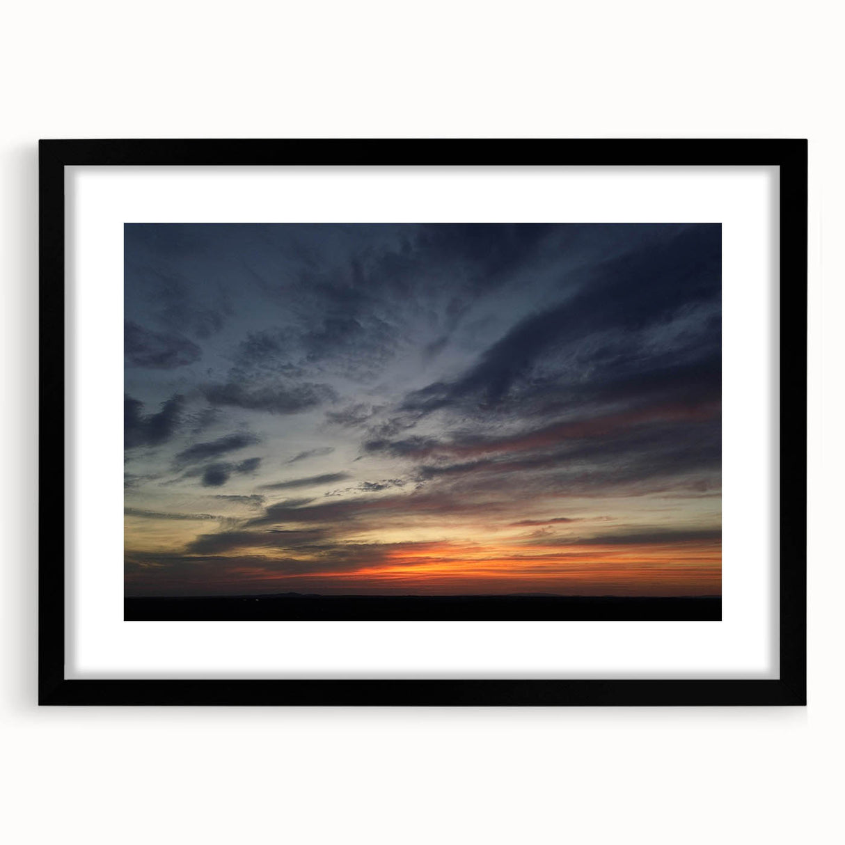 Black-framed wall art print showcasing a serene landscape and skyscape design, featuring soft blues and greens, perfect for enhancing modern home decor.