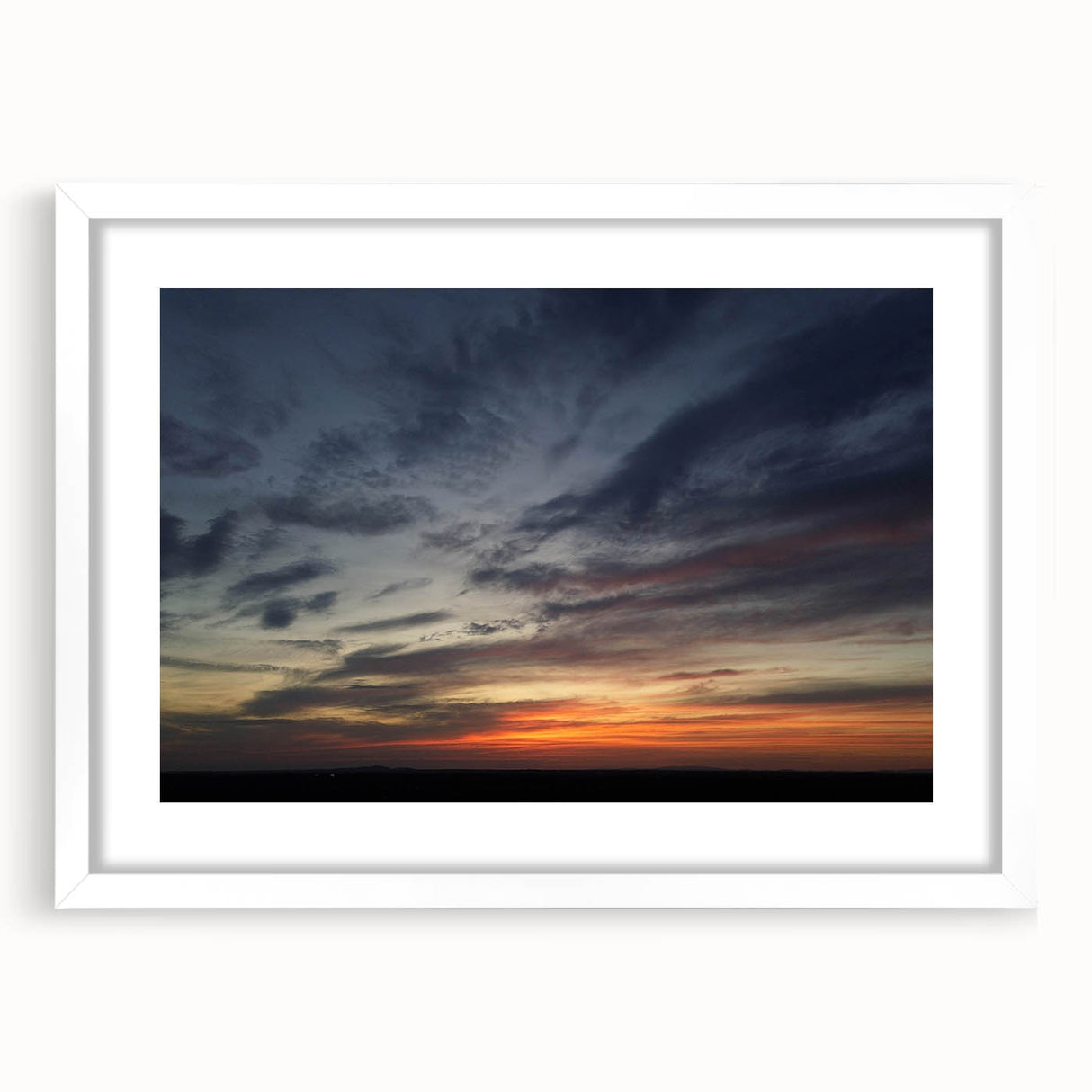Framed landscape wall art collection showcasing serene skyscapes in soft hues, elegantly presented in a white mat and frame, ideal for home decor.