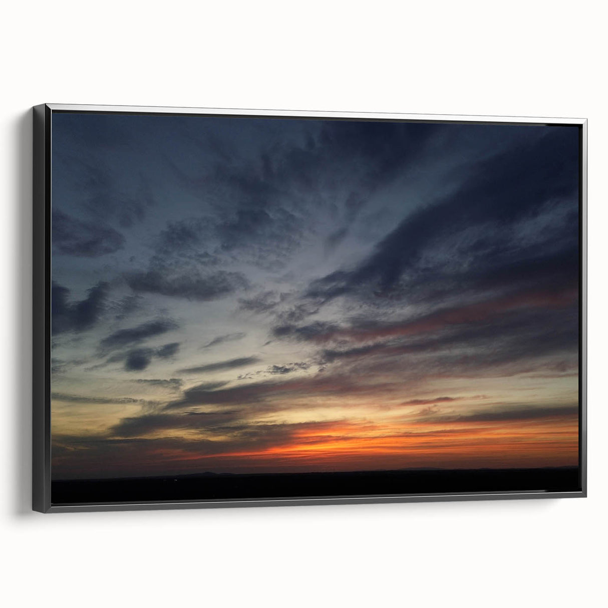 Framed canvas wall art showcasing a serene landscape with vibrant colors, featuring a black frame and a side view, perfect for modern home decor.