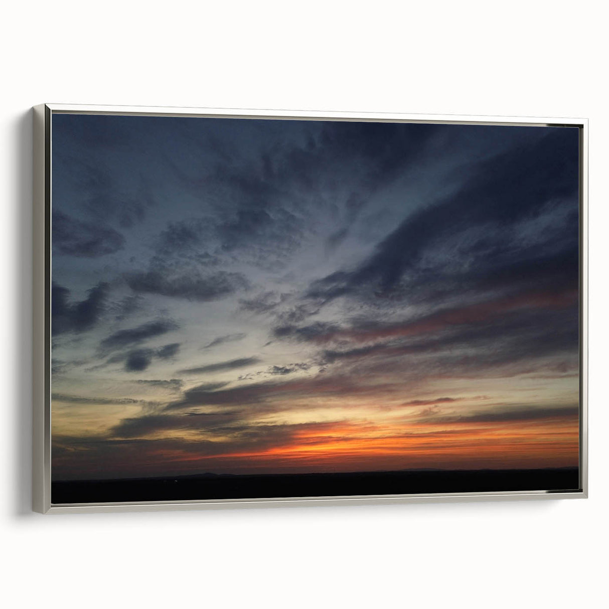 Framed canvas wall art showcasing a serene landscape with vibrant blue skies and silver accents, perfect for enhancing modern home decor.