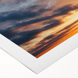 Rolled canvas wall art showcasing a vibrant sunset landscape with rich orange and purple hues, designed for modern decor, beautifully packaged for protection.