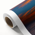Rolled canvas artwork showcasing a vibrant landscape design with a sunset sky in warm hues of orange and pink, expertly packaged in a protective cardboard tube for safe delivery.