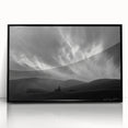Framed acrylic wall art featuring a serene landscape with soft blue skies and lush greenery, set in a sleek black frame, ideal for modern home decor.