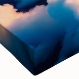 Close-up of a stretched canvas wall art piece showcasing a vibrant landscape design with swirling colors, ideal for modern home decor. The artwork features a blend of blues, greens, and warm tones, creating a serene atmosphere.