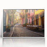 Framed acrylic wall art showcasing a vibrant city street landscape with colorful buildings and a clear blue sky, perfect for adding a modern touch to home decor.
