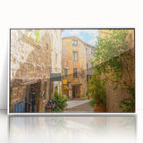 Framed acrylic wall art featuring a vibrant landscape design with colorful streets, displayed in a sleek white frame, perfect for modern home decor.