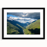 Black-framed wall art featuring a serene valley landscape with vibrant colors, ideal for home decor, showcasing nature's beauty in a modern design.
