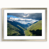 Framed landscape wall art collection showcasing a serene valley design, featuring a sleek silver frame and mat, ideal for modern home decor. This artwork enhances any living space with its tranquil colors and captivating scenery.