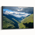Framed canvas wall art showcasing a serene valley landscape design, featuring rich green and blue hues, with a sleek black frame and side view highlighting its elegant finish. Perfect for enhancing home decor with nature-inspired aesthetics.
