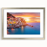Framed wall art collection featuring a serene landscape and village design with a silver mat and frame, showcasing intricate details and vibrant colors, ideal for home decor.