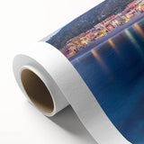 Rolled canvas artwork showcasing a vibrant village landscape scene, featuring lush greenery, colorful houses, and a serene sky, perfect for home decor.