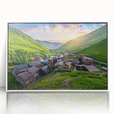 Framed acrylic wall art showcasing a serene village landscape with rolling hills, vibrant colors, and intricate details, perfect for home decor enhancement.