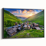 Framed canvas wall art showcasing a picturesque village landscape with vibrant colors, set against a black frame, ideal for home decor. The artwork captures serene rural life, enhancing any living space with its charming aesthetic.