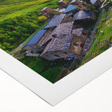 Rolled canvas showcasing a vibrant landscape village design, featuring lush greenery and charming cottages, perfect for home decor. Packaged securely in a cardboard tube.