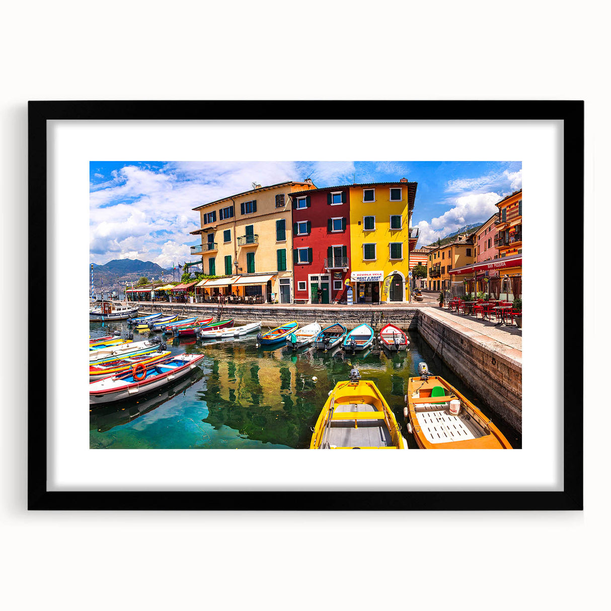 Framed black wall art showcasing a serene village landscape with vibrant colors and intricate details, perfect for enhancing home decor and creating a tranquil ambiance.