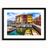 Framed black wall art showcasing a serene village landscape with vibrant colors and intricate details, perfect for enhancing home decor and creating a tranquil ambiance.