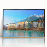 Framed wall art featuring a picturesque village landscape design with vibrant colors and a gold-accented frame, ideal for home decor enthusiasts.