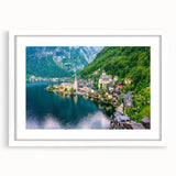 Framed wall art featuring a serene landscape with vibrant colors, showcasing a picturesque village scene. The design includes a white mat and sleek frame, ideal for home decor.