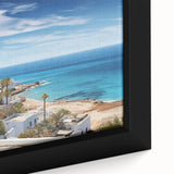 Framed canvas wall art depicting a serene village landscape with lush greenery and vibrant colors, ideal for home decor and enhancing interior aesthetics.