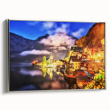 Framed canvas wall art featuring a serene landscape village scene with rich green fields, distant mountains, and a silver frame, ideal for home decor.