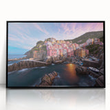 Framed wall art collection featuring a vibrant landscape design of a serene village scene with lush greenery, showcased in a sleek black frame, ideal for home decor.