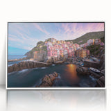 Framed acrylic wall art depicting a serene village landscape with vibrant colors, ideal for home decor, showcasing natural beauty and tranquility.