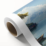 Rolled canvas artwork depicting a serene village landscape with vibrant colors and intricate details, elegantly packaged in a protective cardboard tube for easy display. Perfect for enhancing home decor with a touch of nature-inspired elegance.