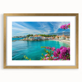 Framed wall art collection featuring a picturesque village landscape with vibrant colors and intricate details, elegantly displayed in a gold frame with a mat.