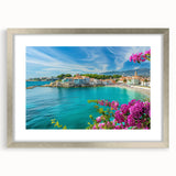 Framed wall art showcasing a picturesque village landscape design, featuring a silver frame and matting for an elegant presentation, perfect for home decor.