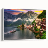 Framed canvas wall art showcasing a serene landscape village design with lush greenery and soft pastel colors, viewed from the side against a white backdrop. This piece adds a tranquil touch to home decor, enhancing any living space with its artistic appeal.