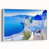 Framed canvas wall art featuring a picturesque village landscape with vibrant colors and intricate details, ideal for home decor. The white frame enhances its aesthetic appeal.
