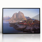 Framed wall art showcasing a serene village landscape design with vibrant colors, set in a sleek black frame, perfect for home decor enhancement.