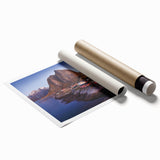 Rolled print showcasing a vibrant landscape village design in warm tones, ideal for home decor, presented in a protective cardboard tube for safe shipping.
