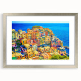 Framed wall art showcasing a serene village landscape with vibrant colors, silver matting, and a sleek design, perfect for enhancing home decor aesthetics.